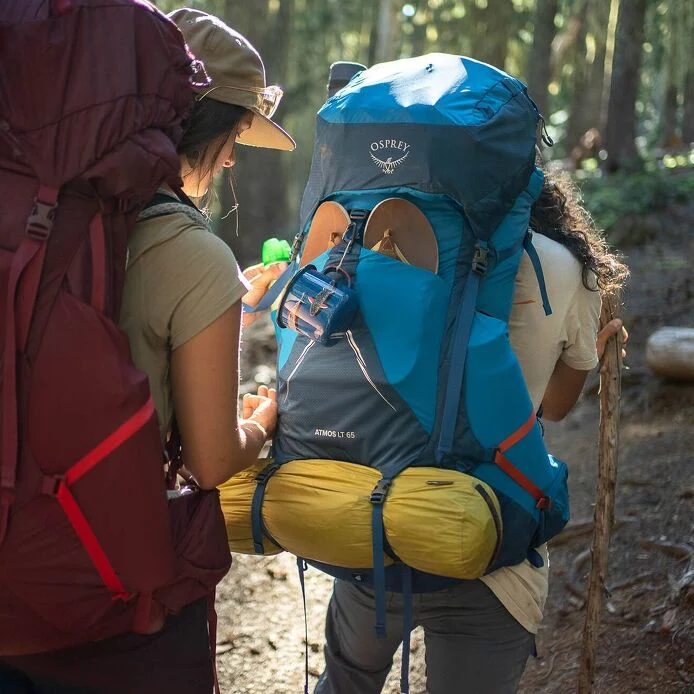 Blue Osprey Atmos AG LT 65 backpack loaded with hiking equipment