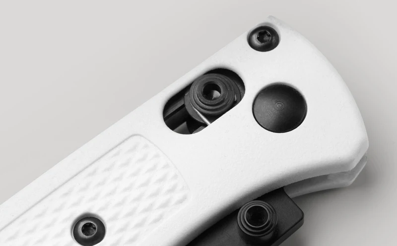 Macro view of the Benchmade Mini Bugout AXIS lock bar and thumb stud