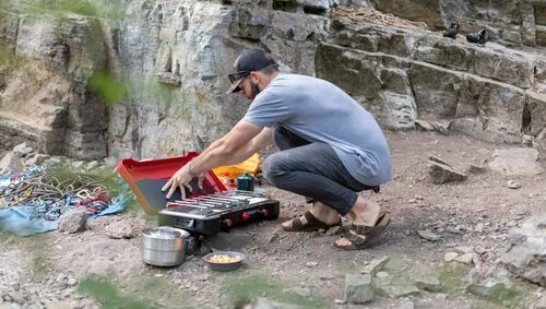 Camp Chef Everest 2X being set up at a rocky campsite