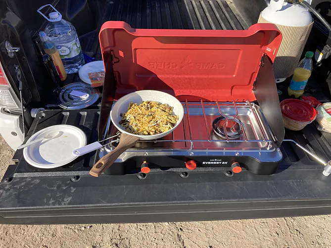 Camp Chef Everest 2X set up for cooking on a vehicle tailgate