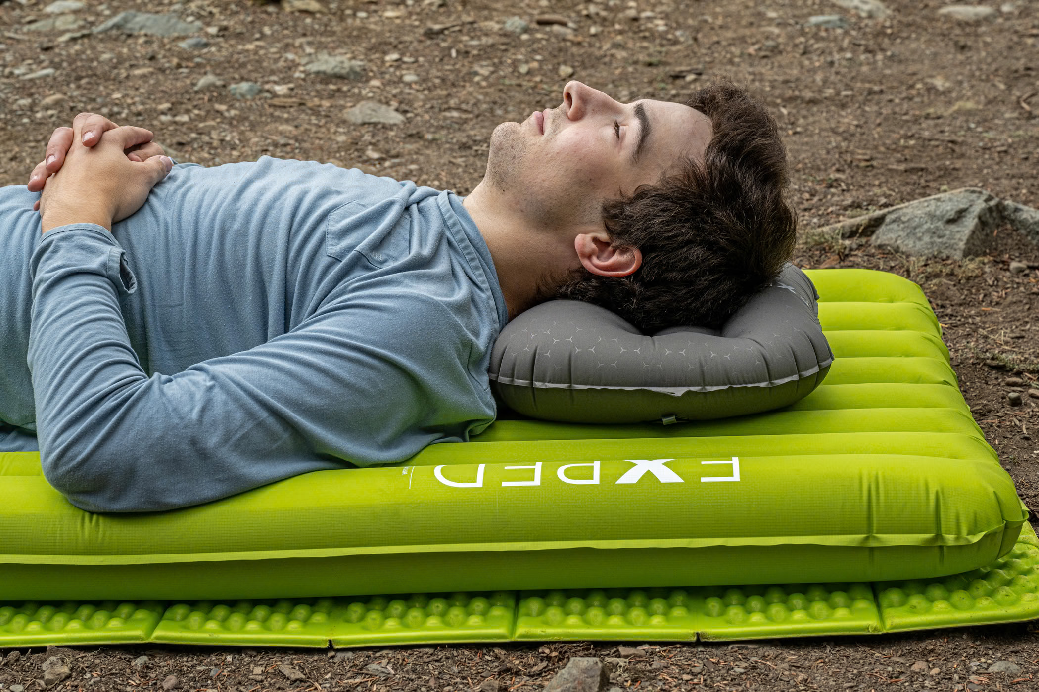 The lime-green Exped Ultra 6.5R sleeping mat in use at camp