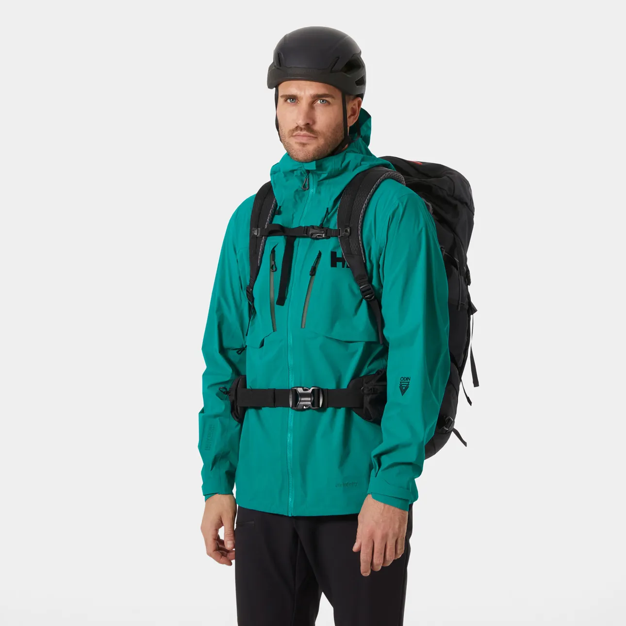 Hiker wearing the Helly Hansen Odin Ultimate Infinity Shell Jacket beneath a backpack