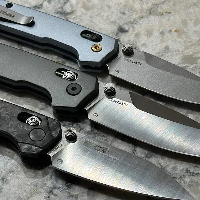 Several Kershaw folding knives with crossbar-style locks and different blade finishes