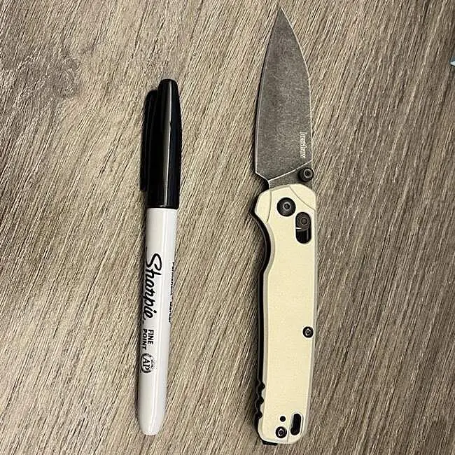 Kershaw Bel Air beside a standard marker for scale
