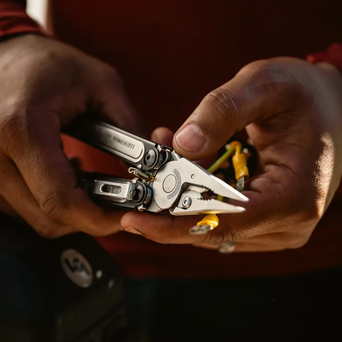 Leatherman ARC pliers being used on an electrical wire connection