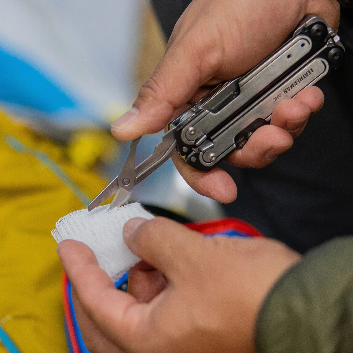 Leatherman ARC scissors cutting gauze during a first aid task
