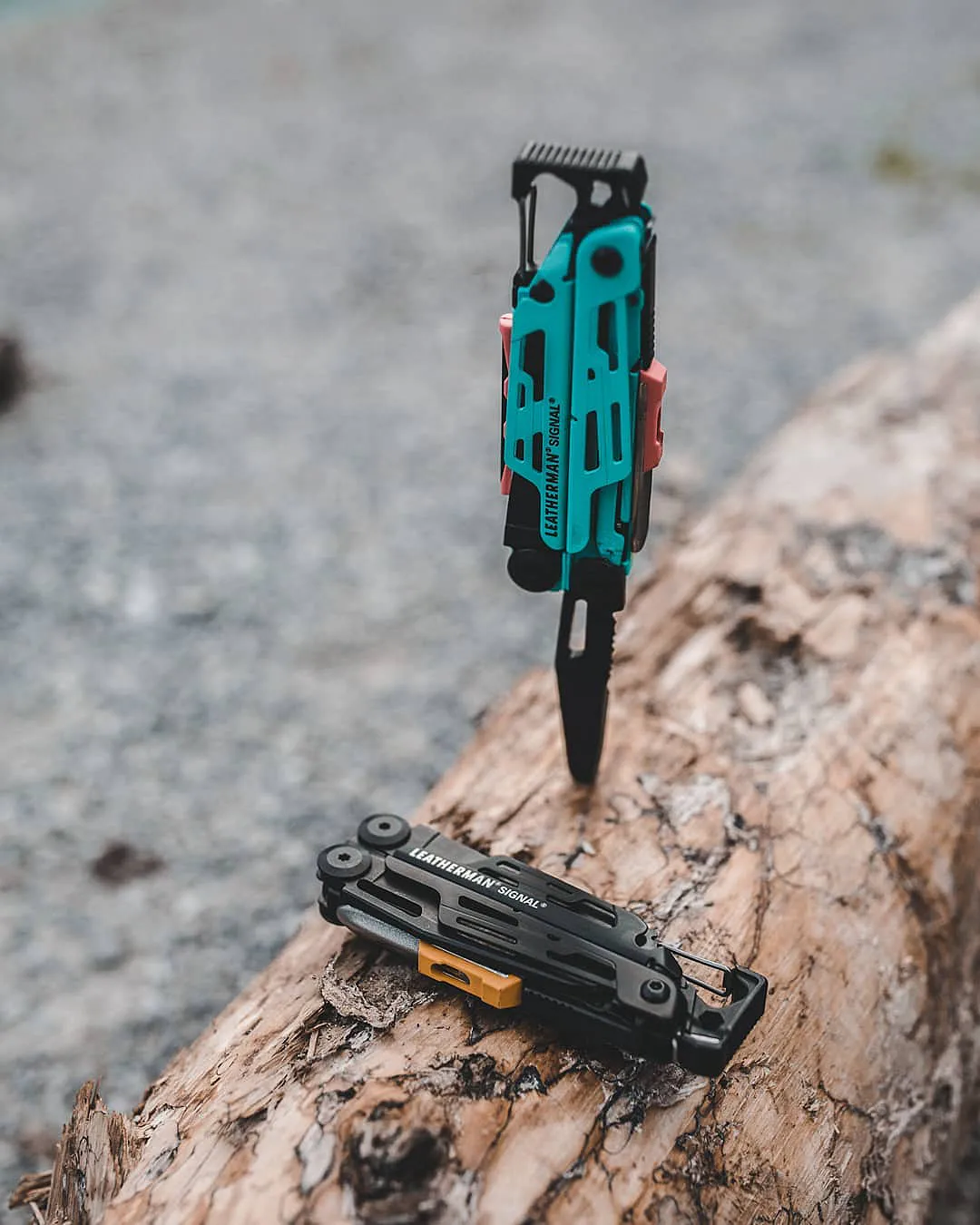 Leatherman Signal using a driver bit against a piece of wood outdoors