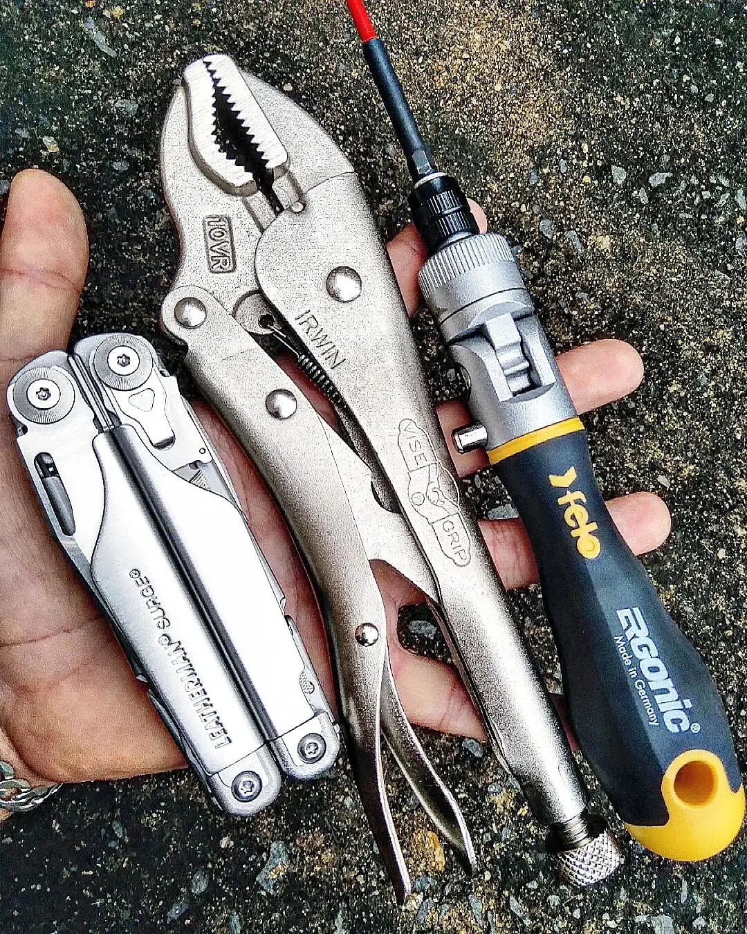 Leatherman Surge beside dedicated locking pliers and a screwdriver