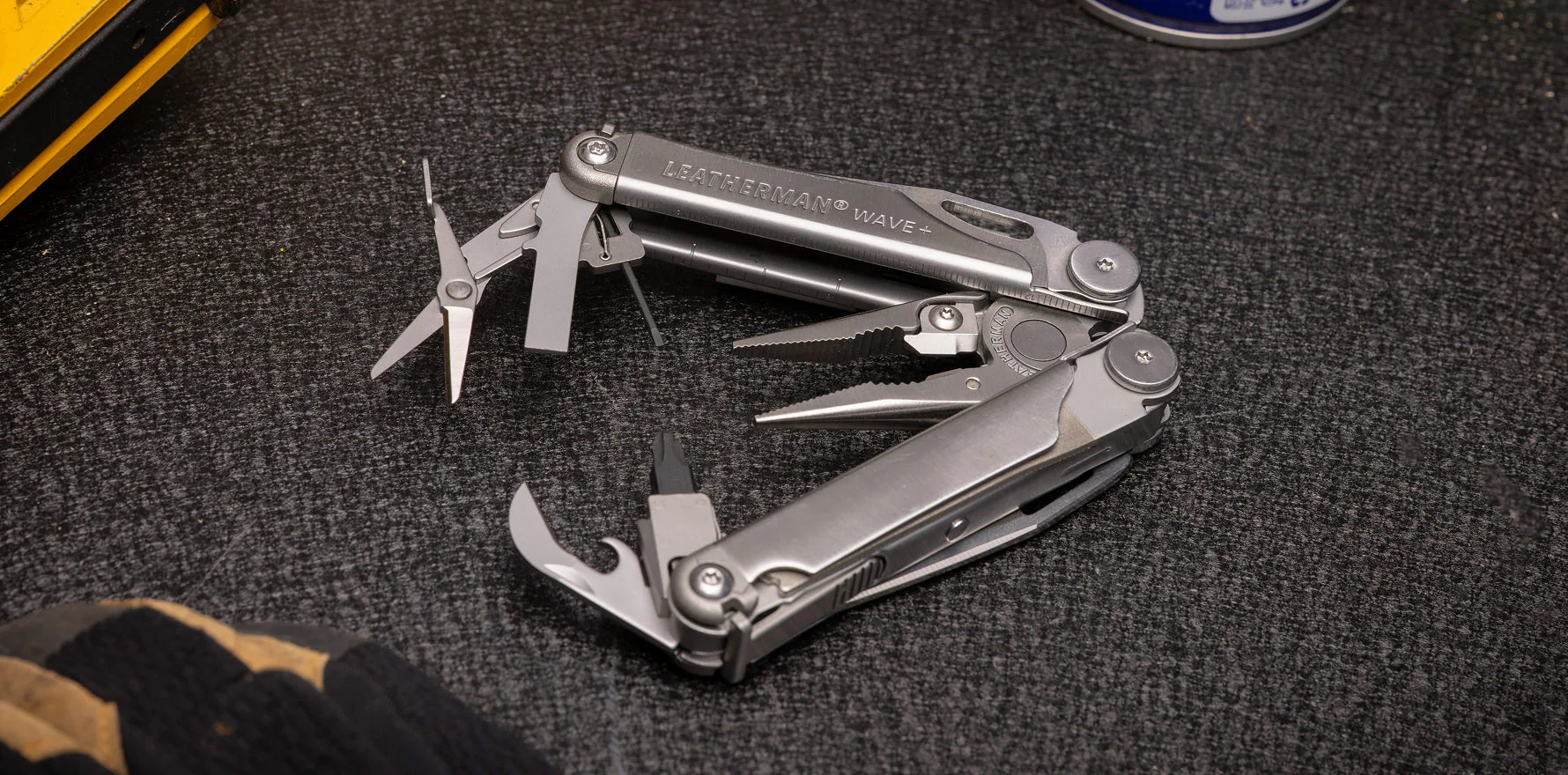 Stainless Leatherman Wave+ open on a workshop surface