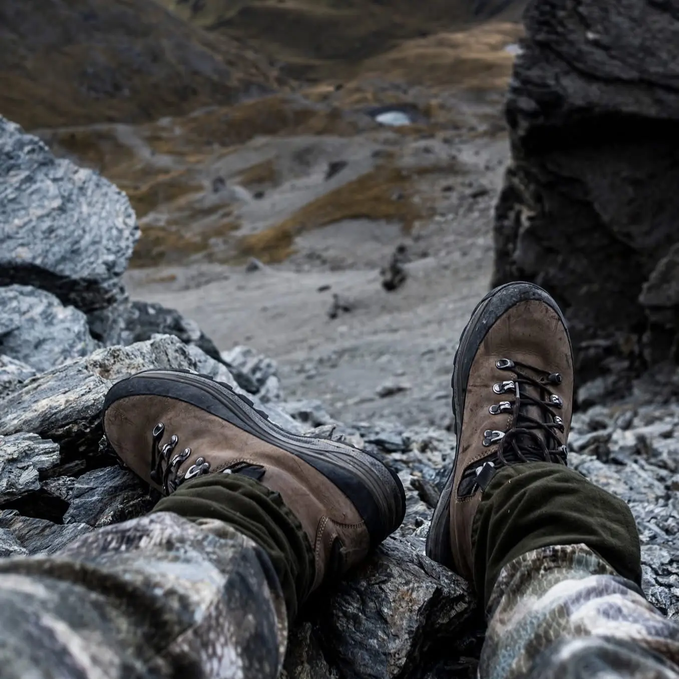 LOWA Renegade Evo GTX Mid boots resting on rocky alpine terrain
