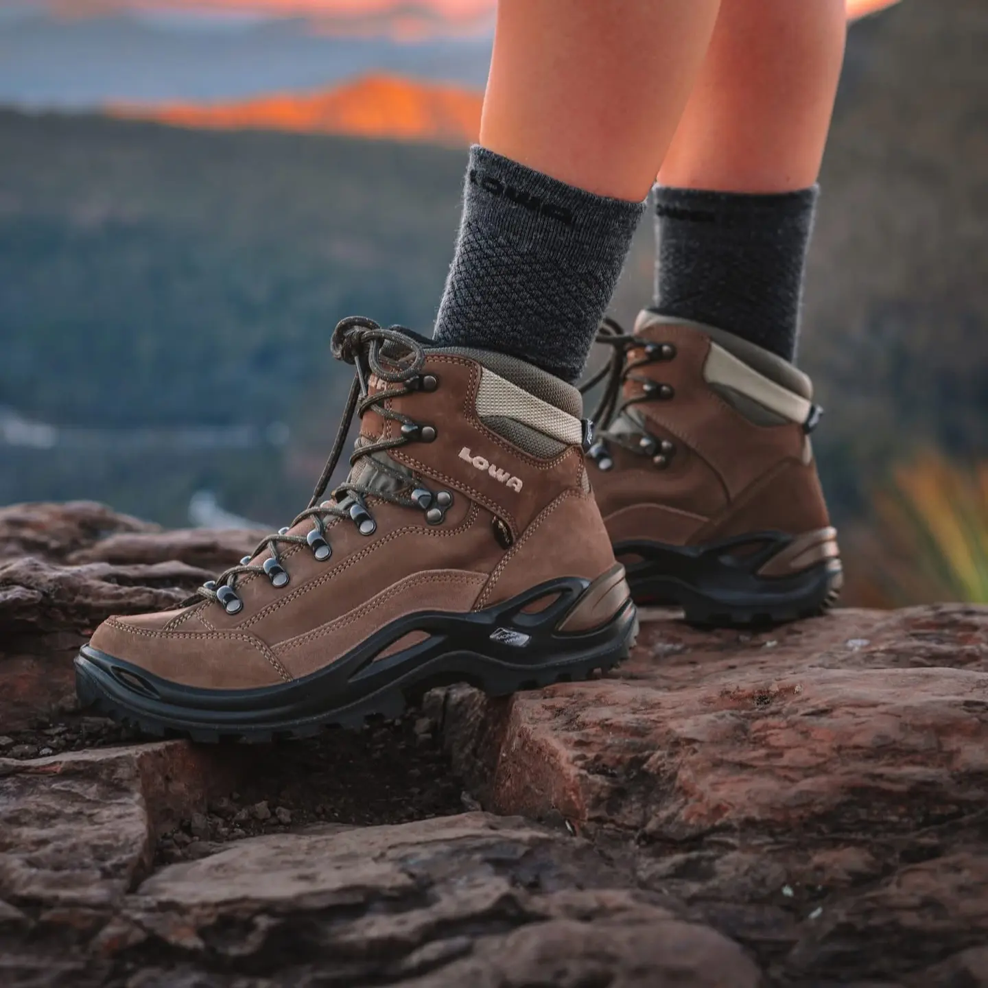 Hiker wearing LOWA Renegade Evo GTX Mid boots on an open trail