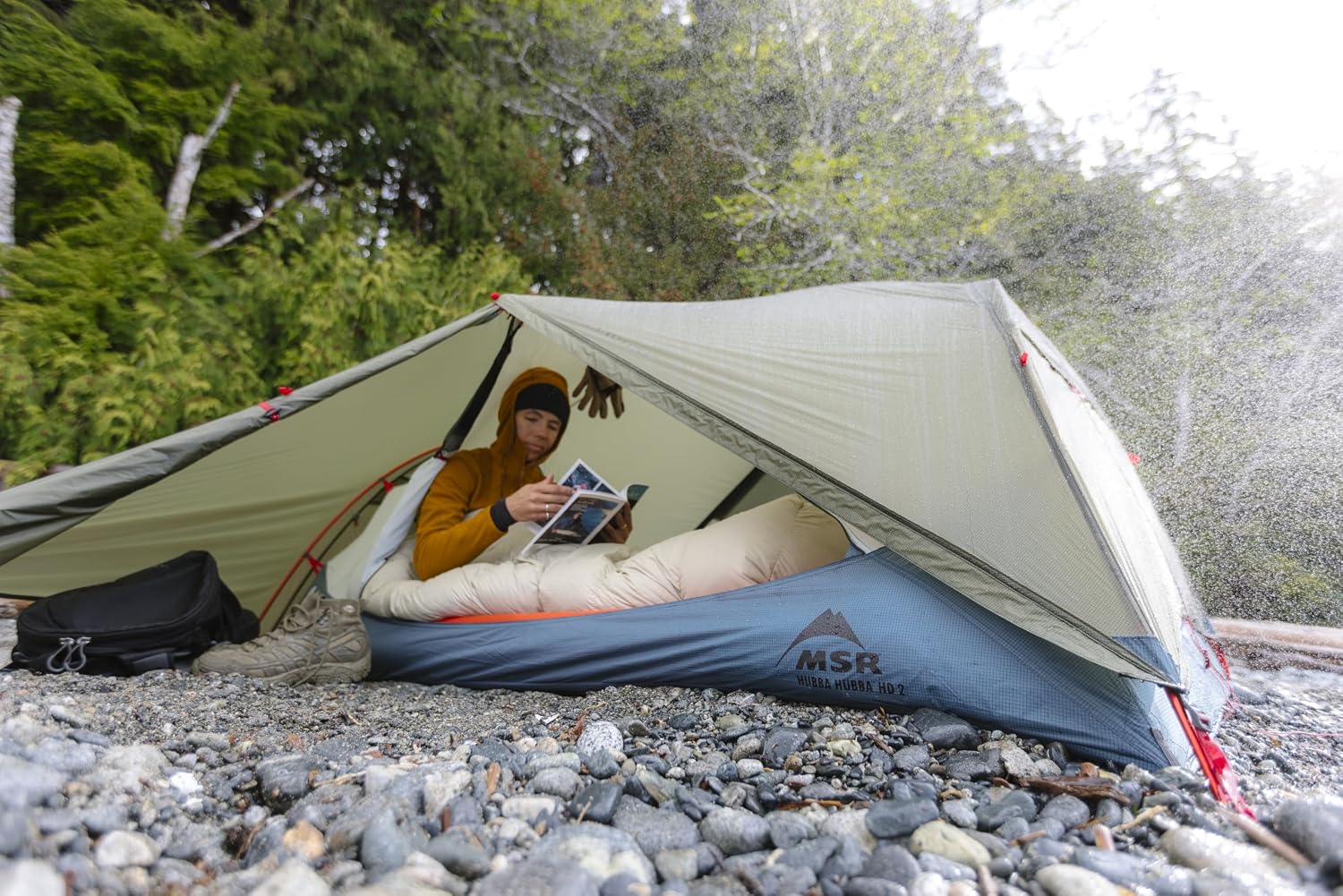 Camper sheltered inside the MSR Hubba Hubba HD 2 during heavy rain