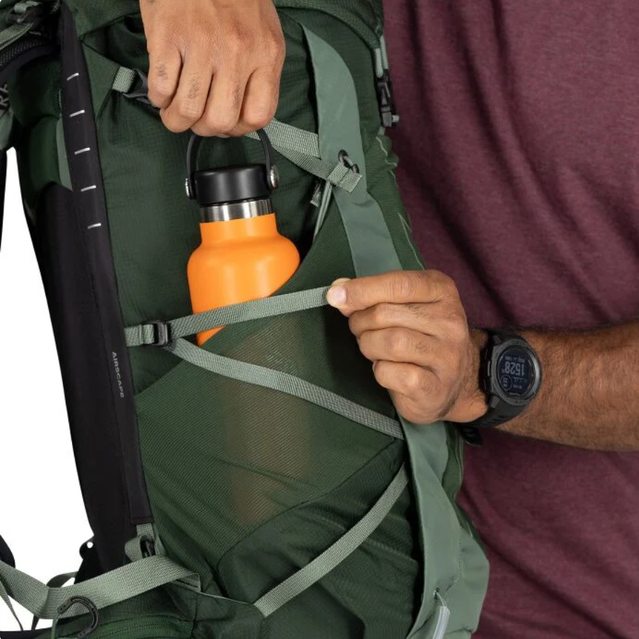 Side mesh bottle pocket secured by compression straps