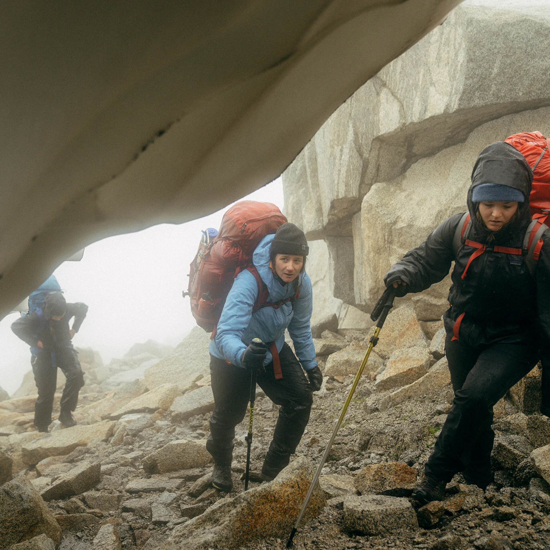 Hikers wearing Patagonia Torrentshell 3L jackets in wet mountain conditions