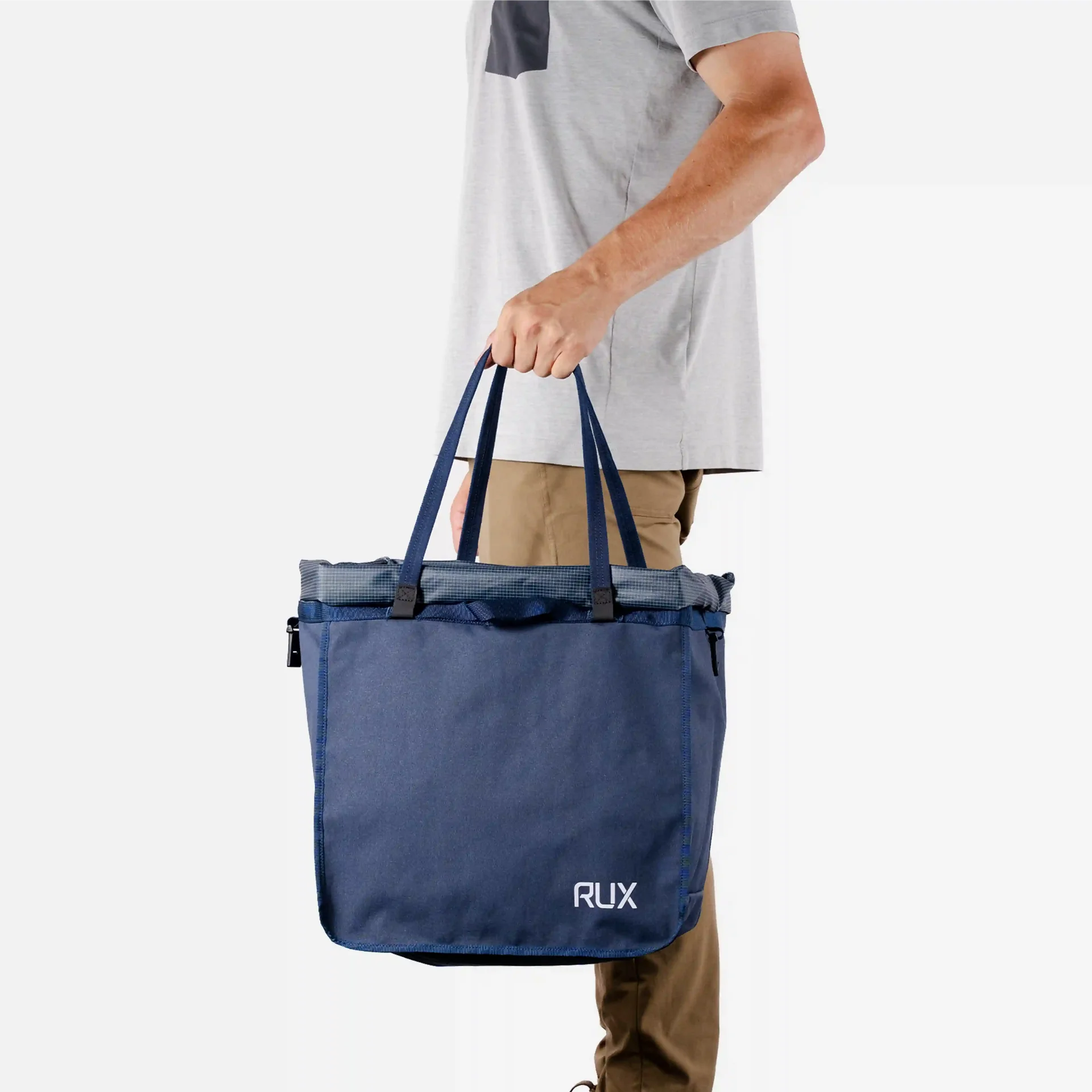 RUX Bag 25L carried by its long webbing handles
