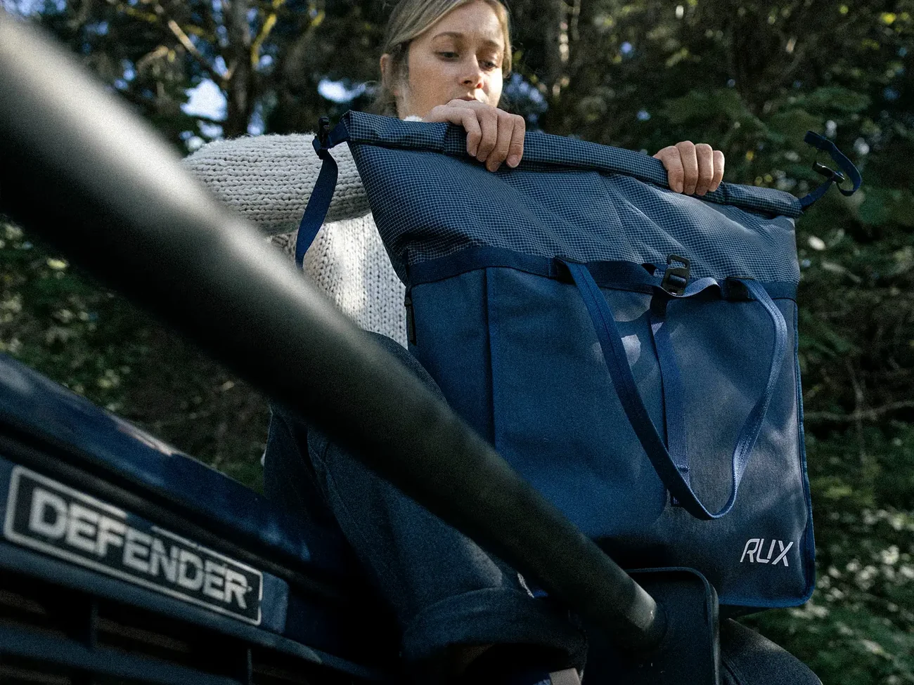 RUX Bag 25L with its upper fabric rolled toward the closure