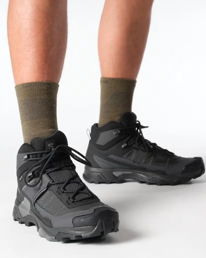 Black Salomon X Ultra 5 Mid GTX hiking boots worn on foot