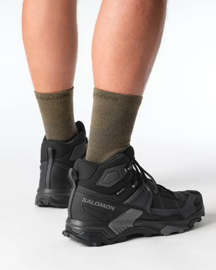 Black Salomon X Ultra 5 Mid GTX hiking boots shown from the rear while worn
