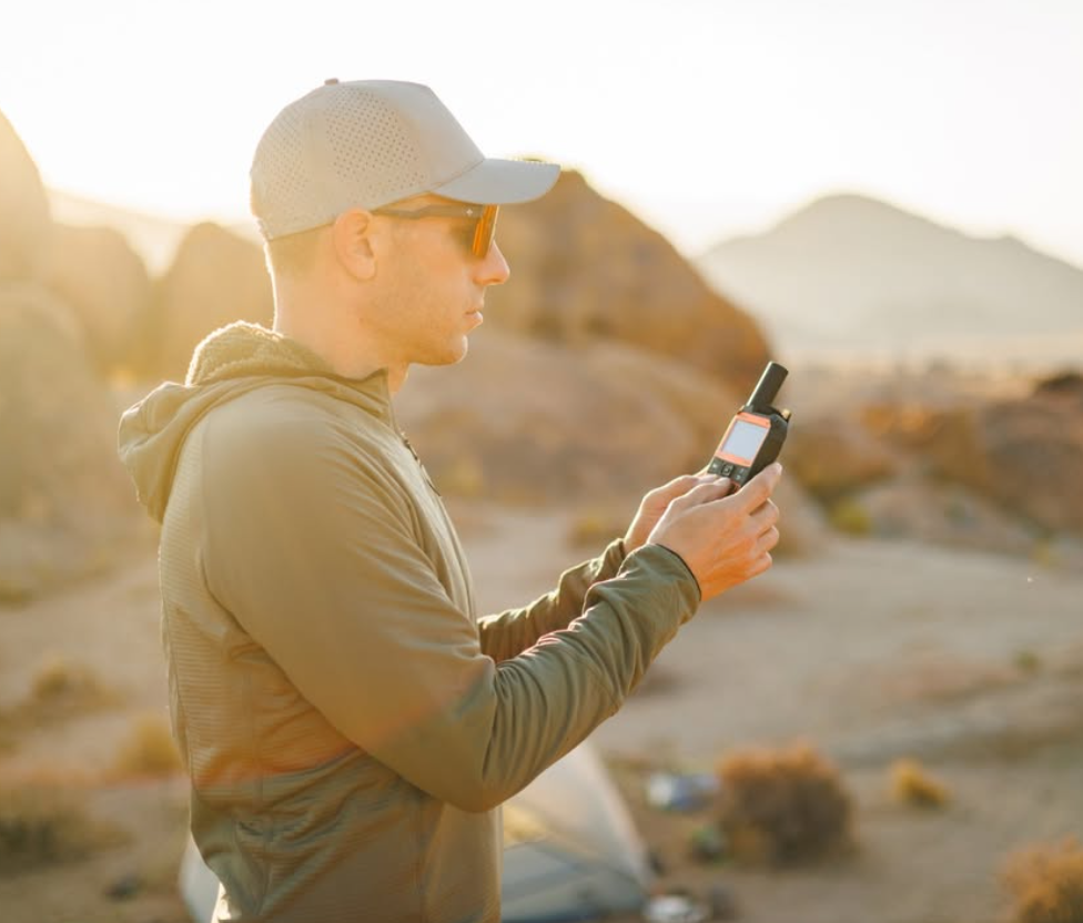 Person composing a message on SPOT X outdoors